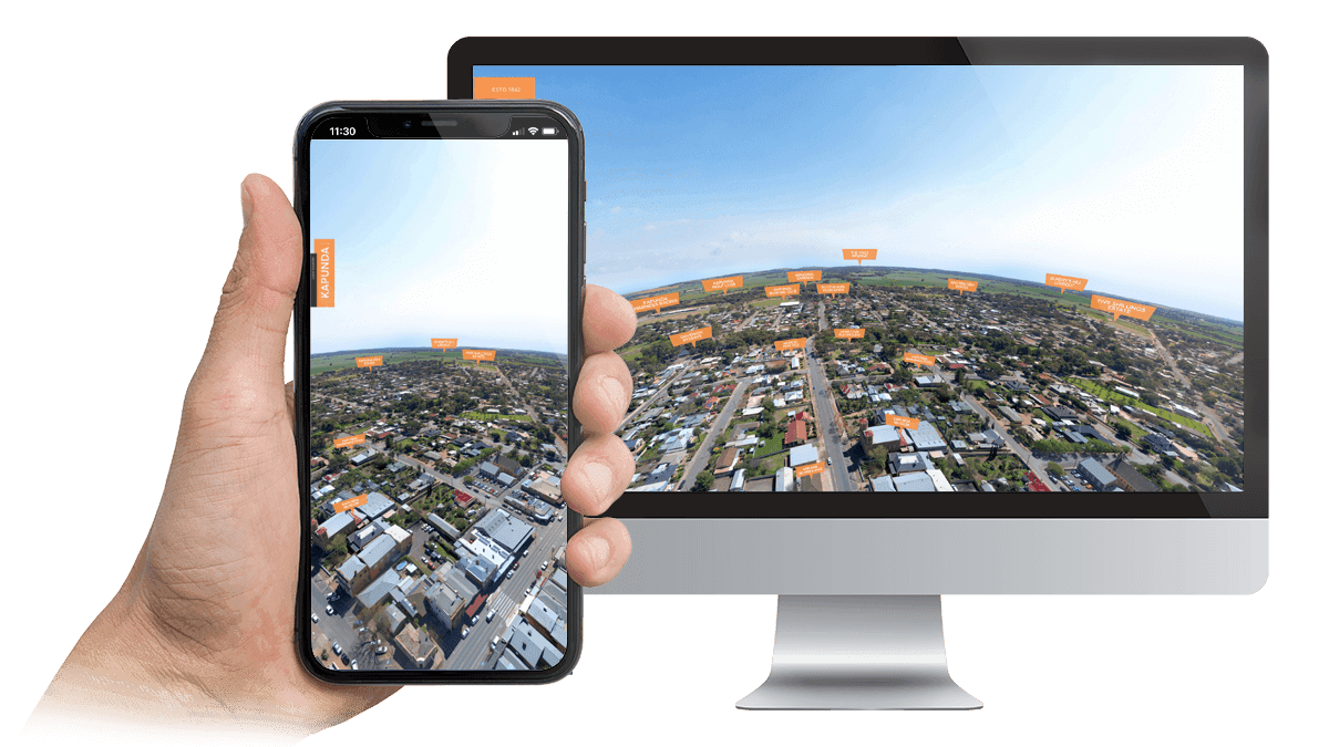 Light Invest aerial town view page displayed on a desktop monitor and smartphone