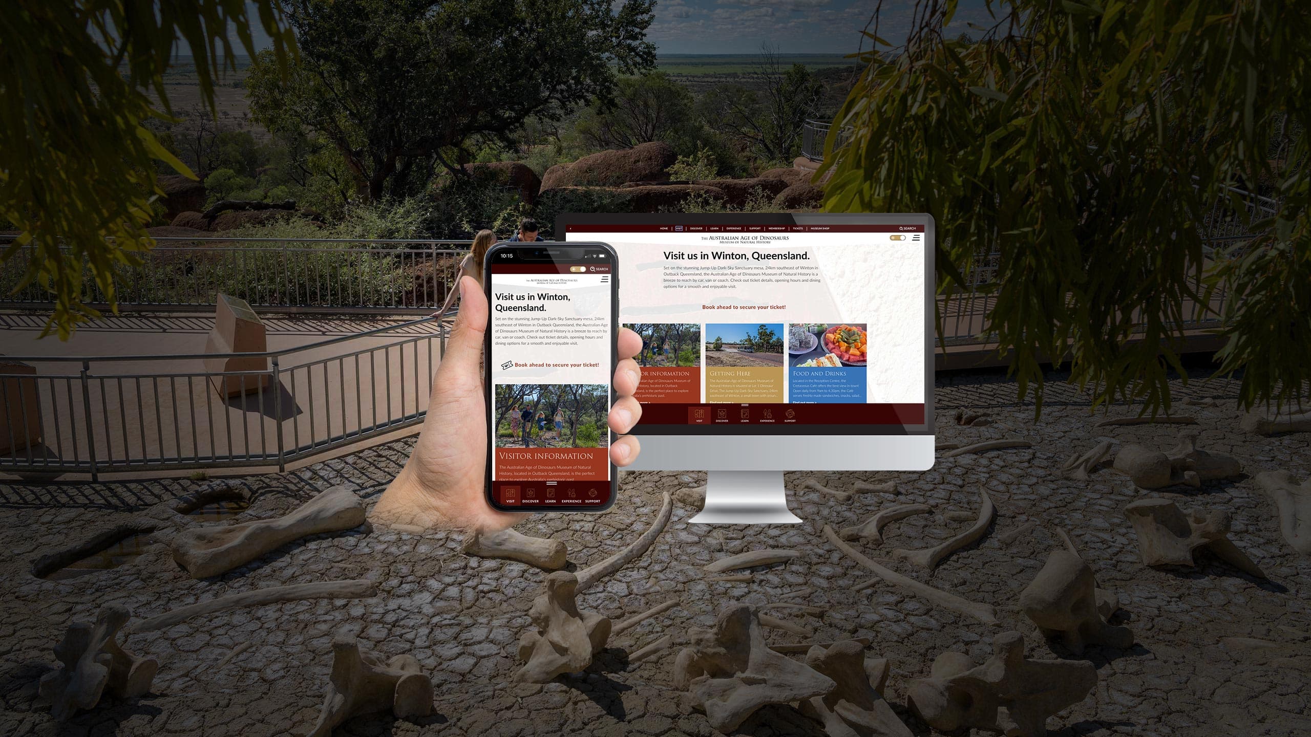 Australian Age of Dinosaurs website displayed on a desktop monitor and smartphone at the museum's outdoor exhibit