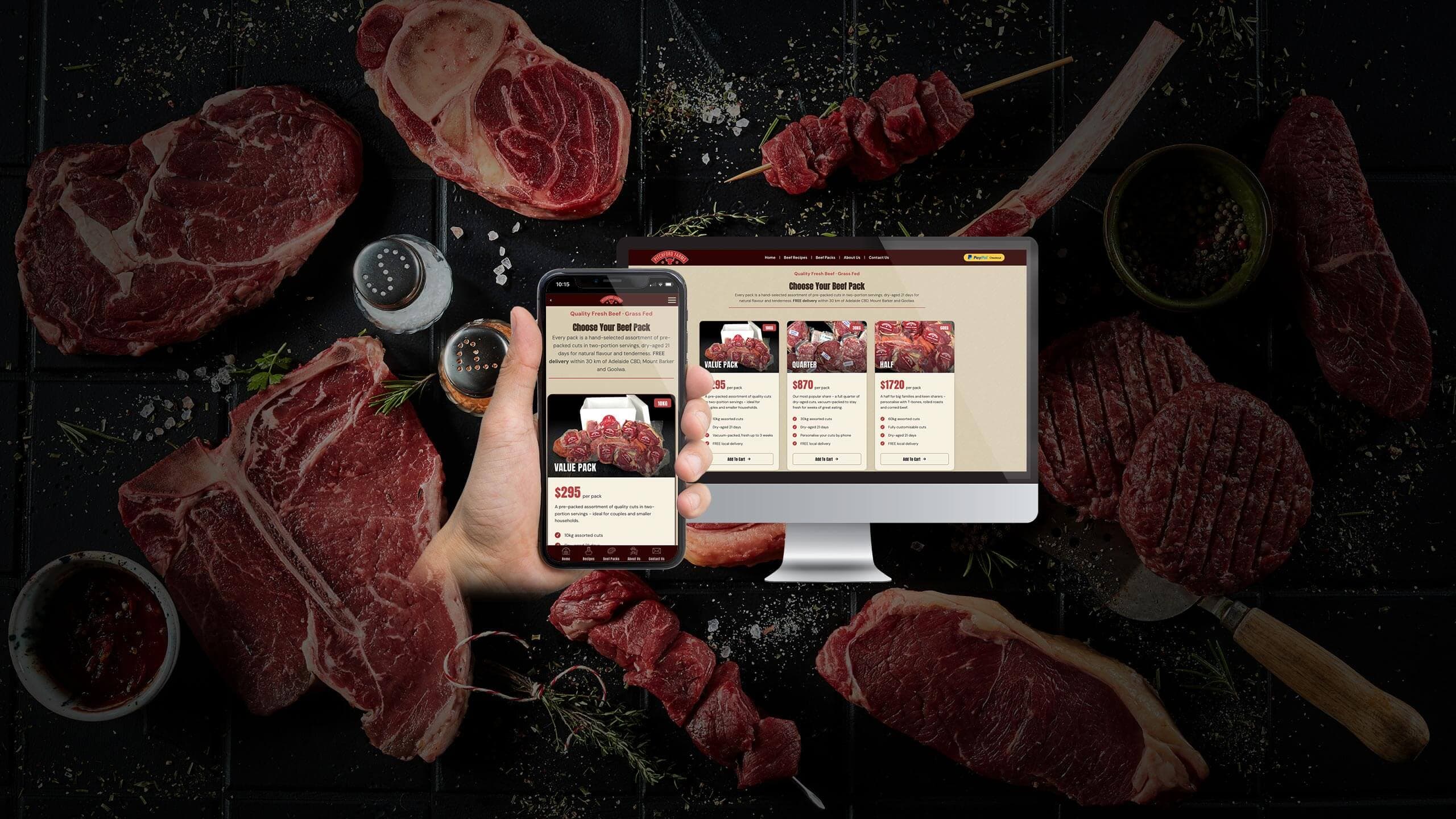Pitchford Farms beef pack page on a desktop monitor and smartphone over raw steaks on a dark bench