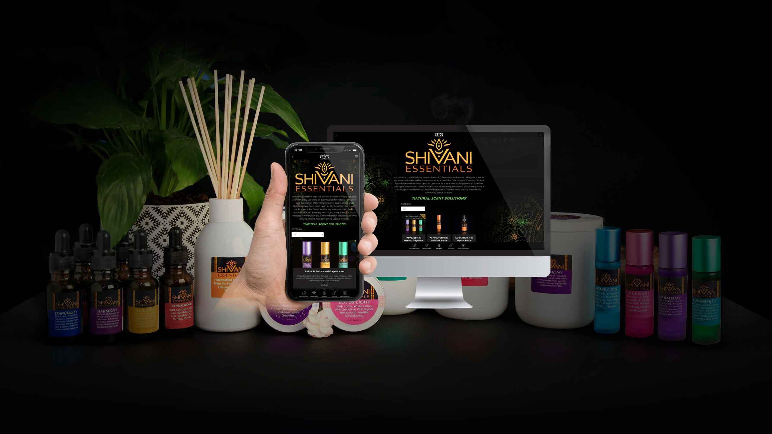 Shivani Essentials website mockup displayed among natural fragrance oils, reed diffusers and candles
