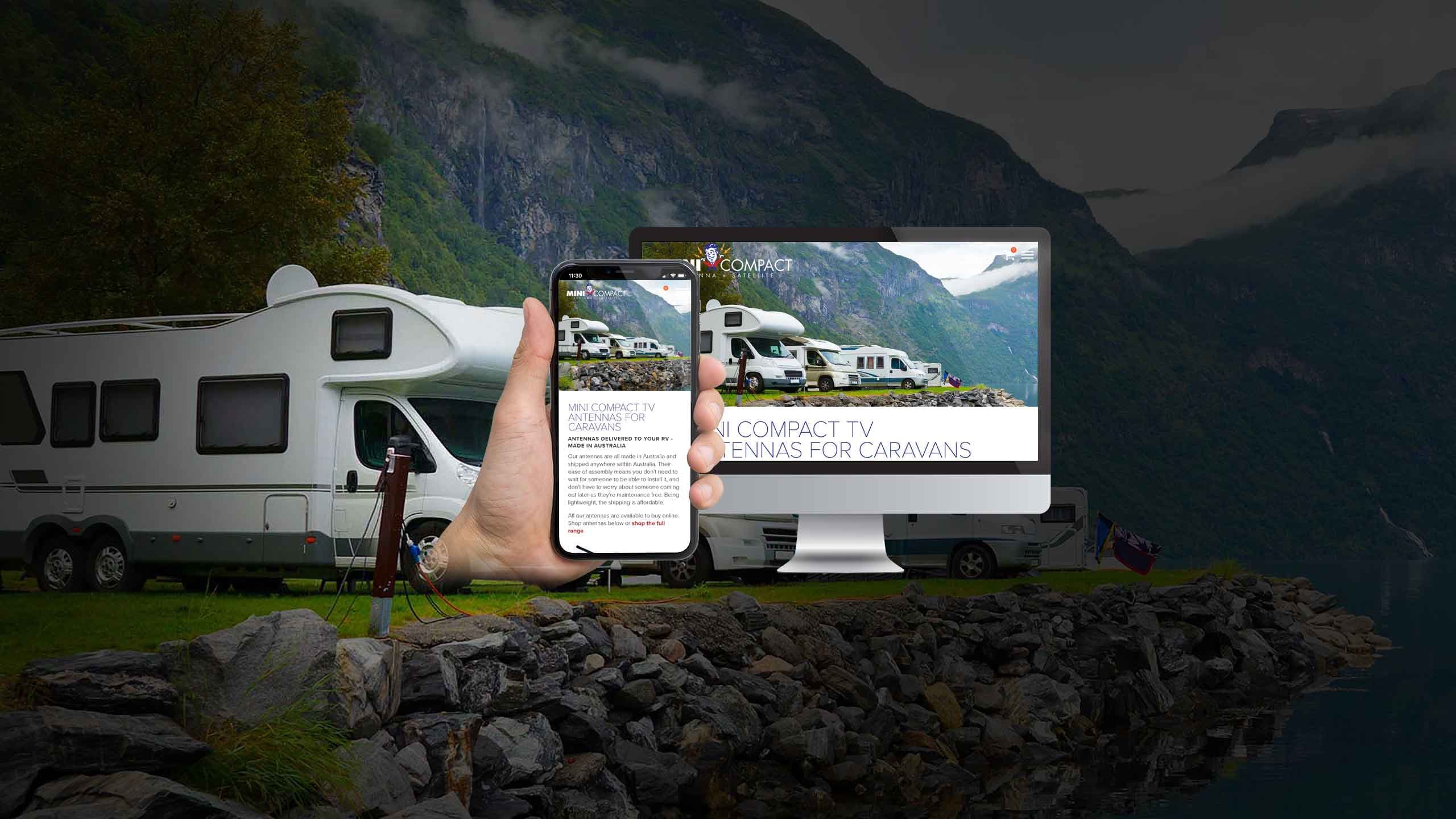 Mini Compact caravan TV antenna website displayed on a desktop monitor and smartphone against caravans parked by a fjord