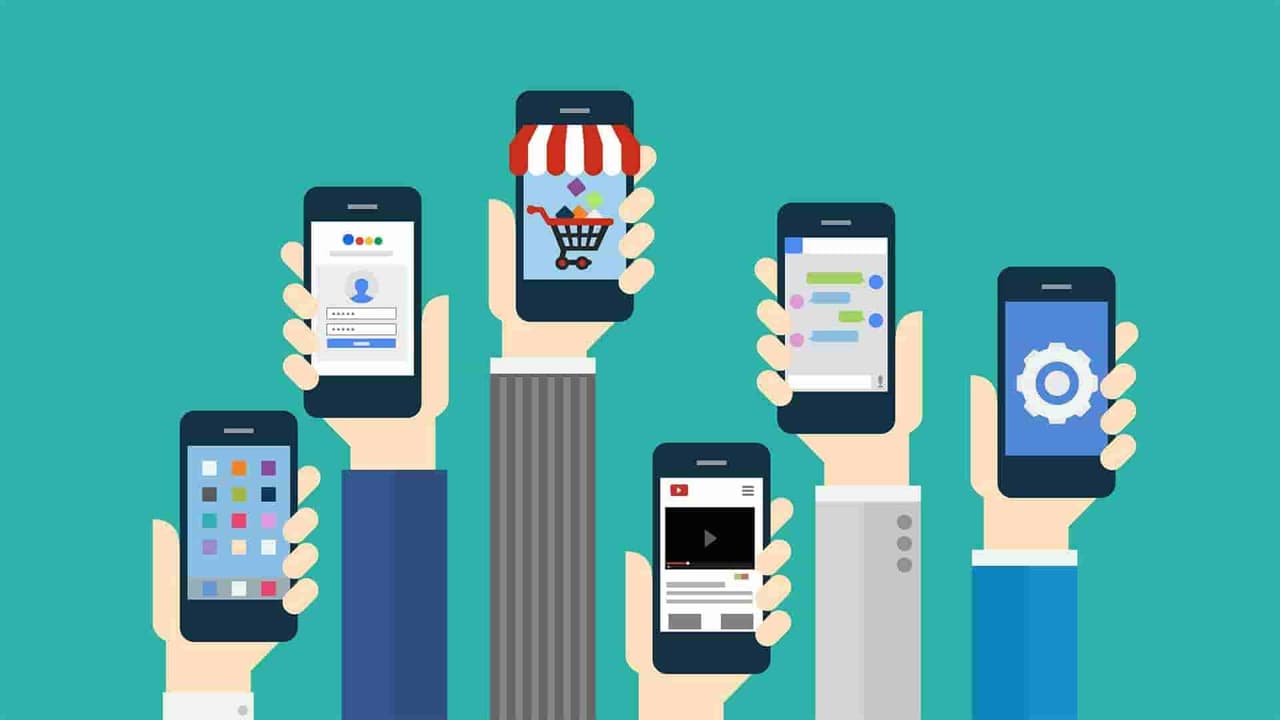 Hands holding smartphones showing login, shopping, video and chat app icons, illustrating progressive web apps