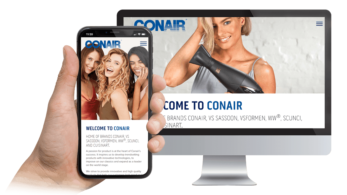 Conair website displayed on a desktop monitor and smartphone