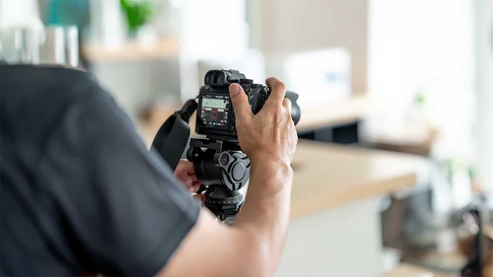 Photographer shooting product images on a camera and tripod for content creation