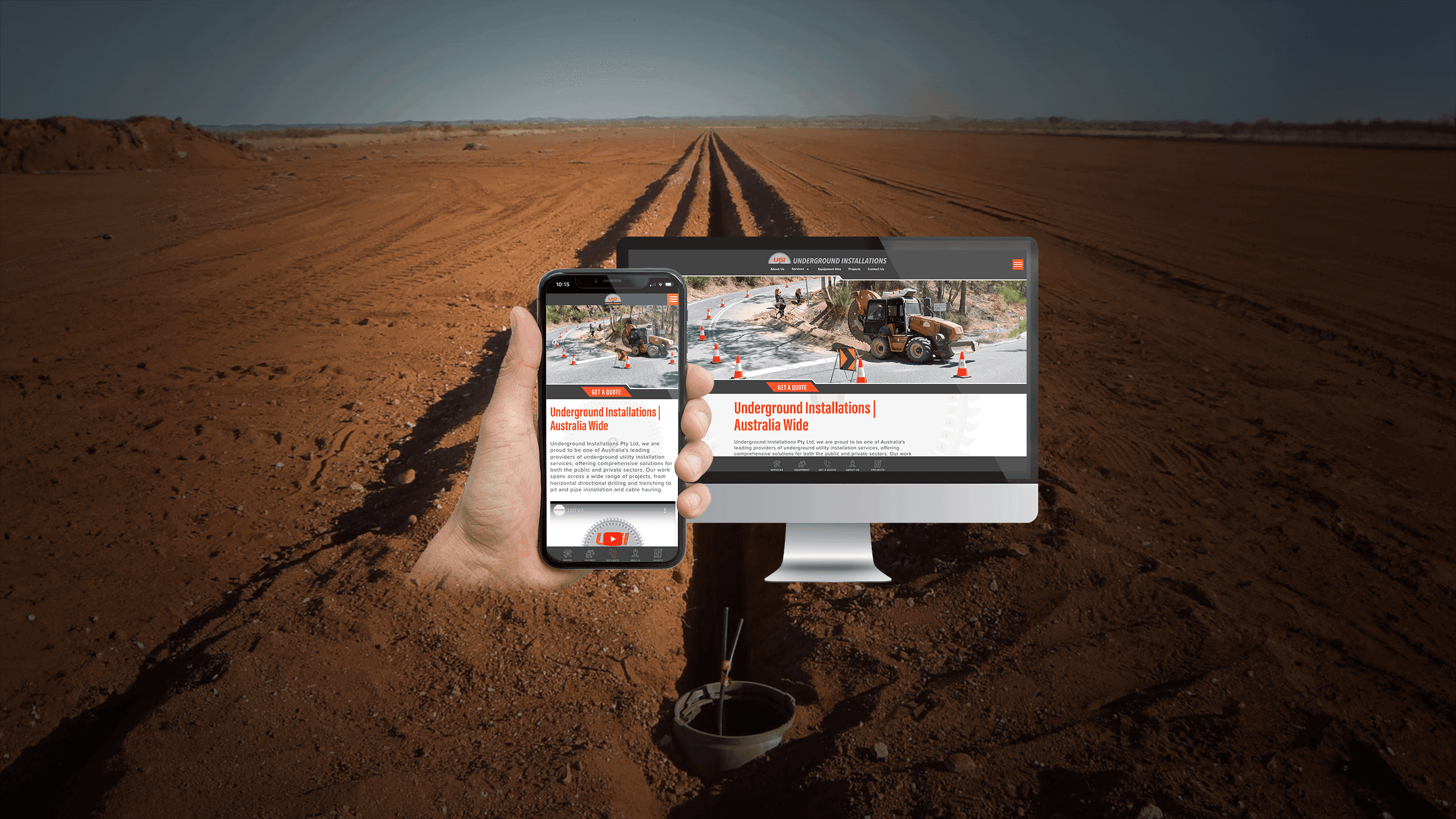 Underground Installations homepage on a desktop monitor and smartphone over a red dirt roadworks backdrop