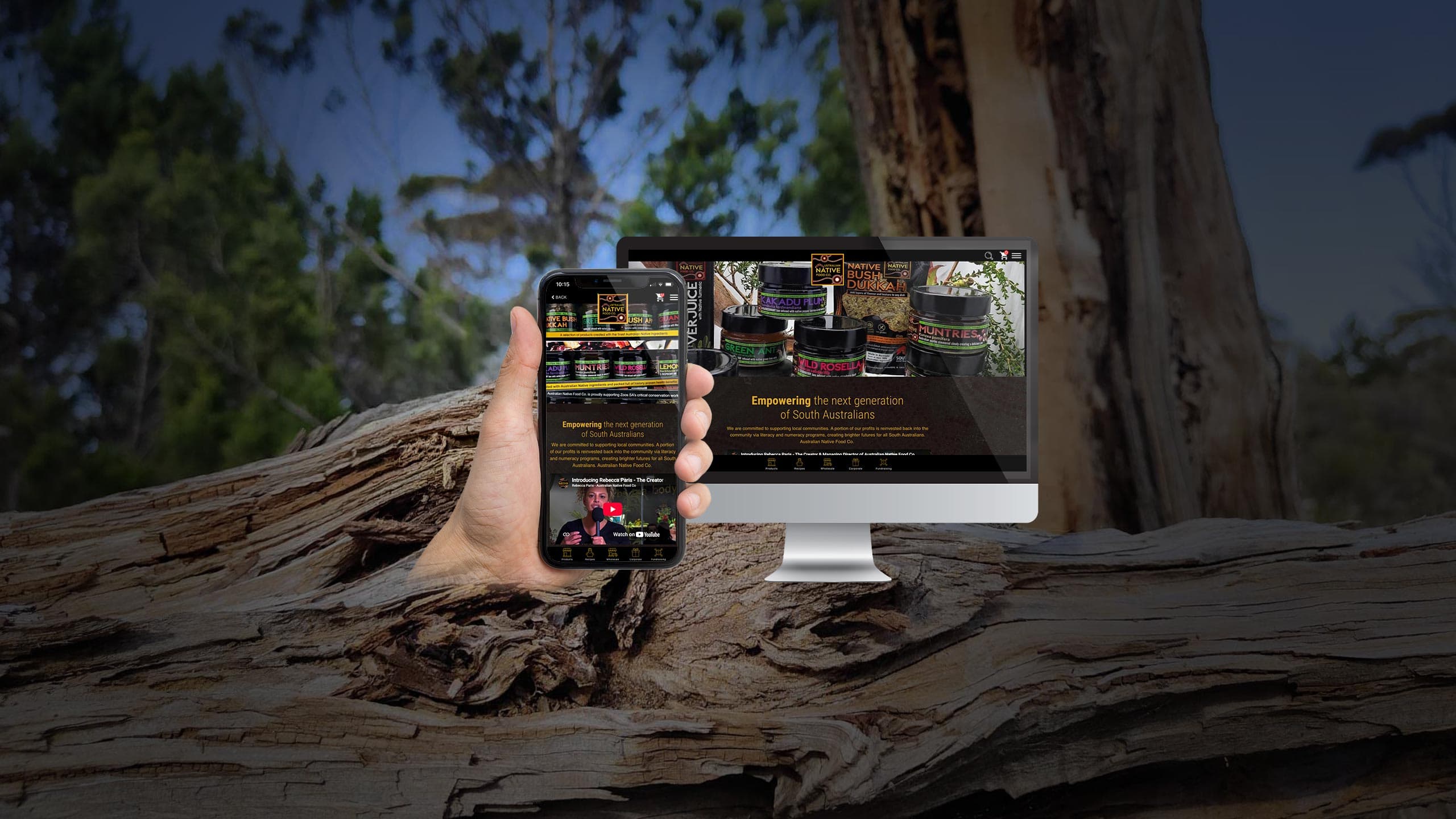 Australian Native Food Co homepage displayed on a desktop monitor and smartphone over a fallen gum tree in bushland