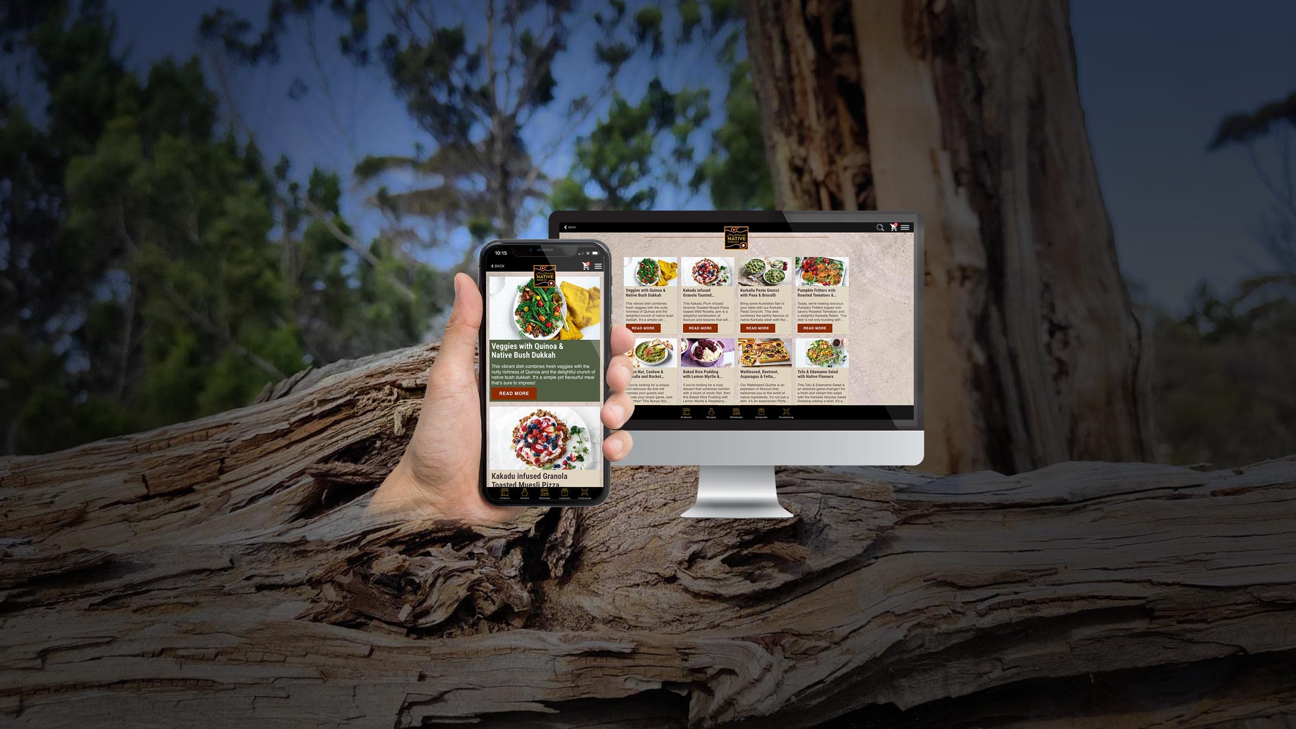 Australian Native Food Co recipes page displayed on a desktop monitor and smartphone over a fallen gum tree in bushland