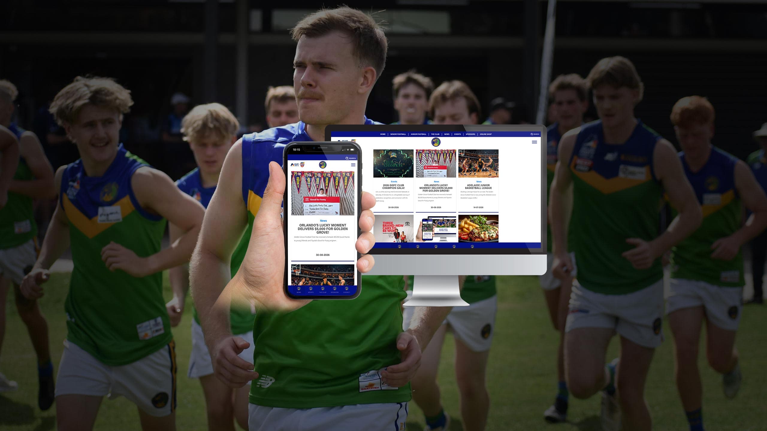 Golden Grove Football Club players running onto the field behind a monitor and phone showing the website's news and events page