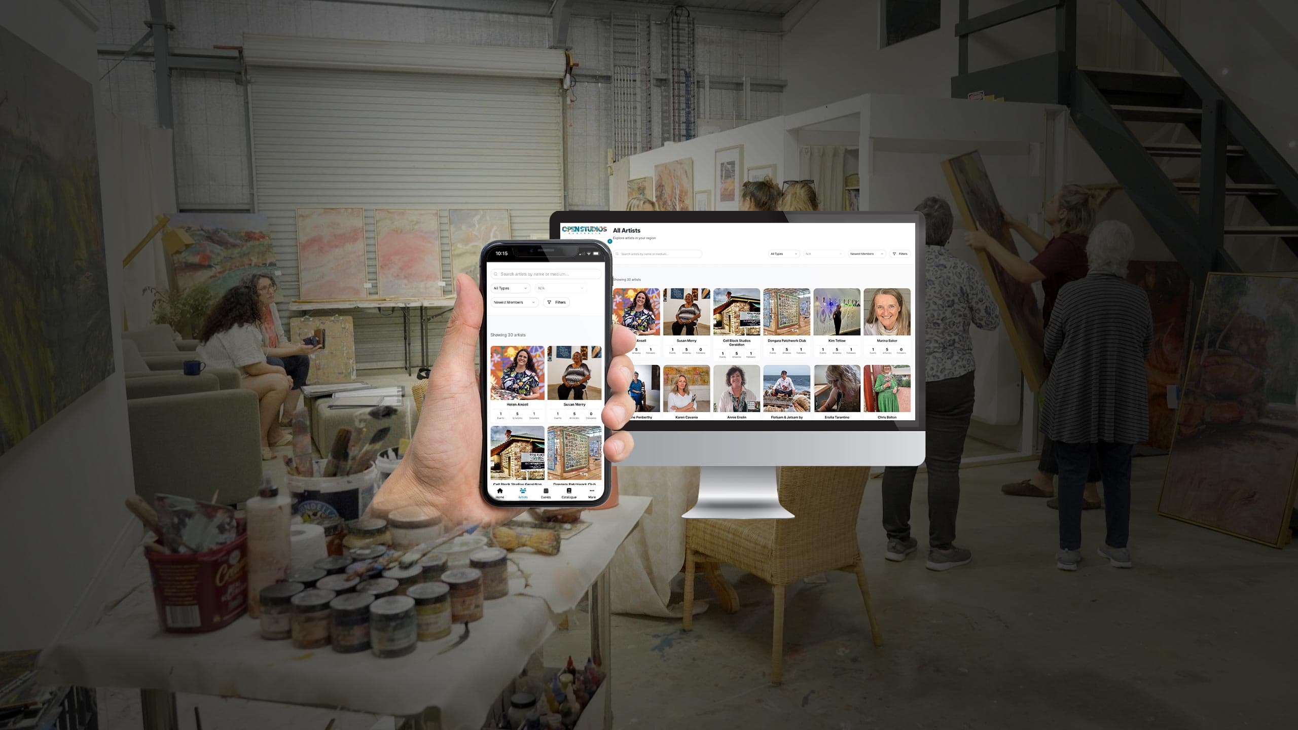 Open Studios Australia artist directory on a monitor and phone, in an artist's studio with paintings and paint pots