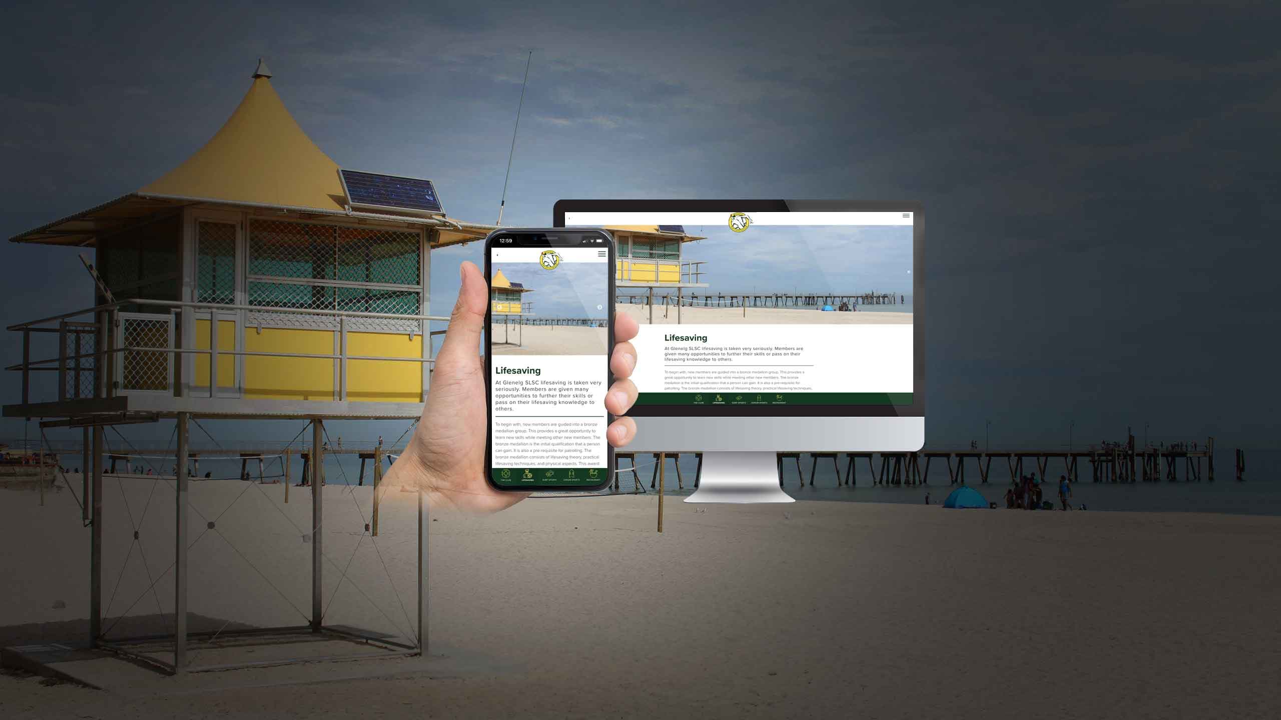 Glenelg lifeguard tower on the beach with the Glenelg SLSC Lifesaving page shown on a smartphone and monitor