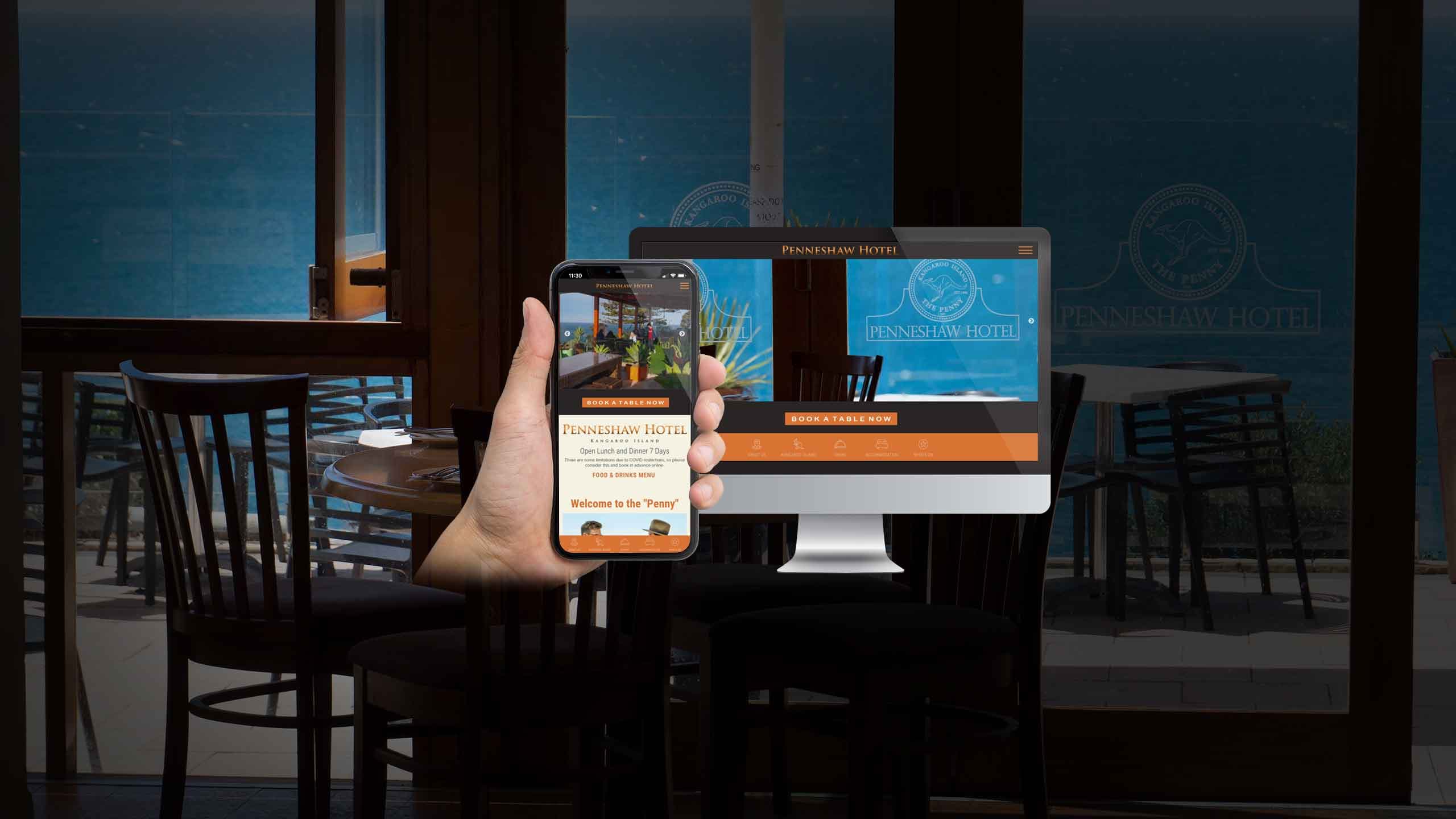 Penneshaw Hotel website displayed on a desktop monitor and smartphone within the venue's dining terrace