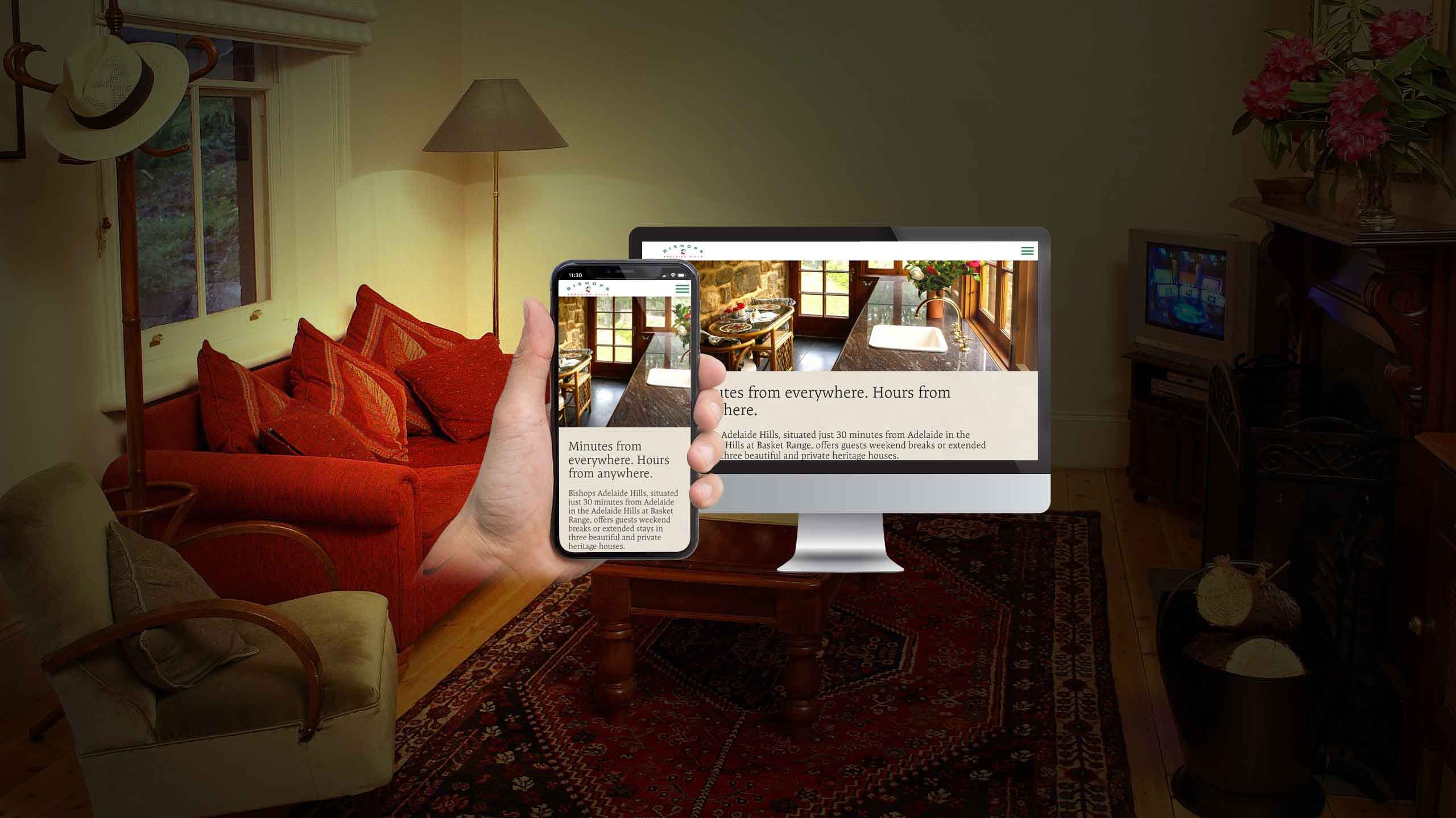 Bishops Adelaide Hills website displayed on a desktop monitor and smartphone in a cosy heritage living room