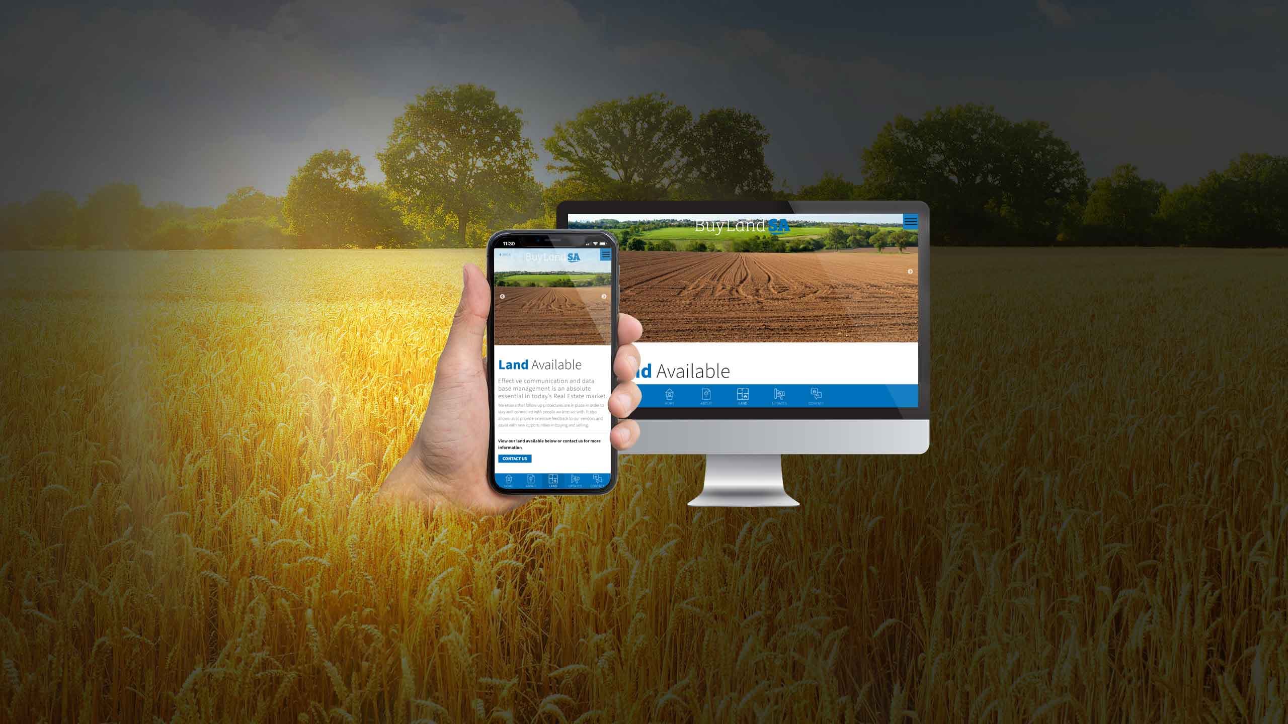 Buy Land SA Land Available page displayed on a desktop monitor and smartphone over a wheat field