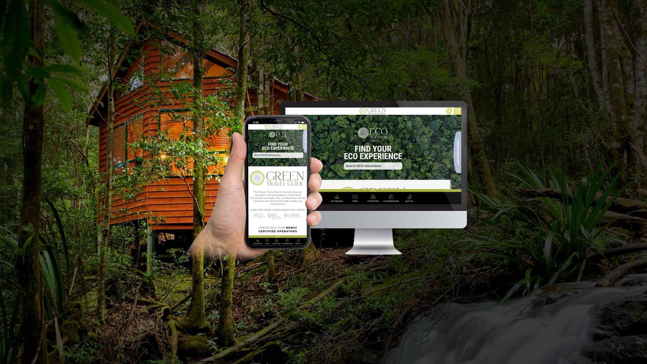 Green Travel Guide website homepage displayed on a desktop monitor and smartphone in a forest eco-cabin setting