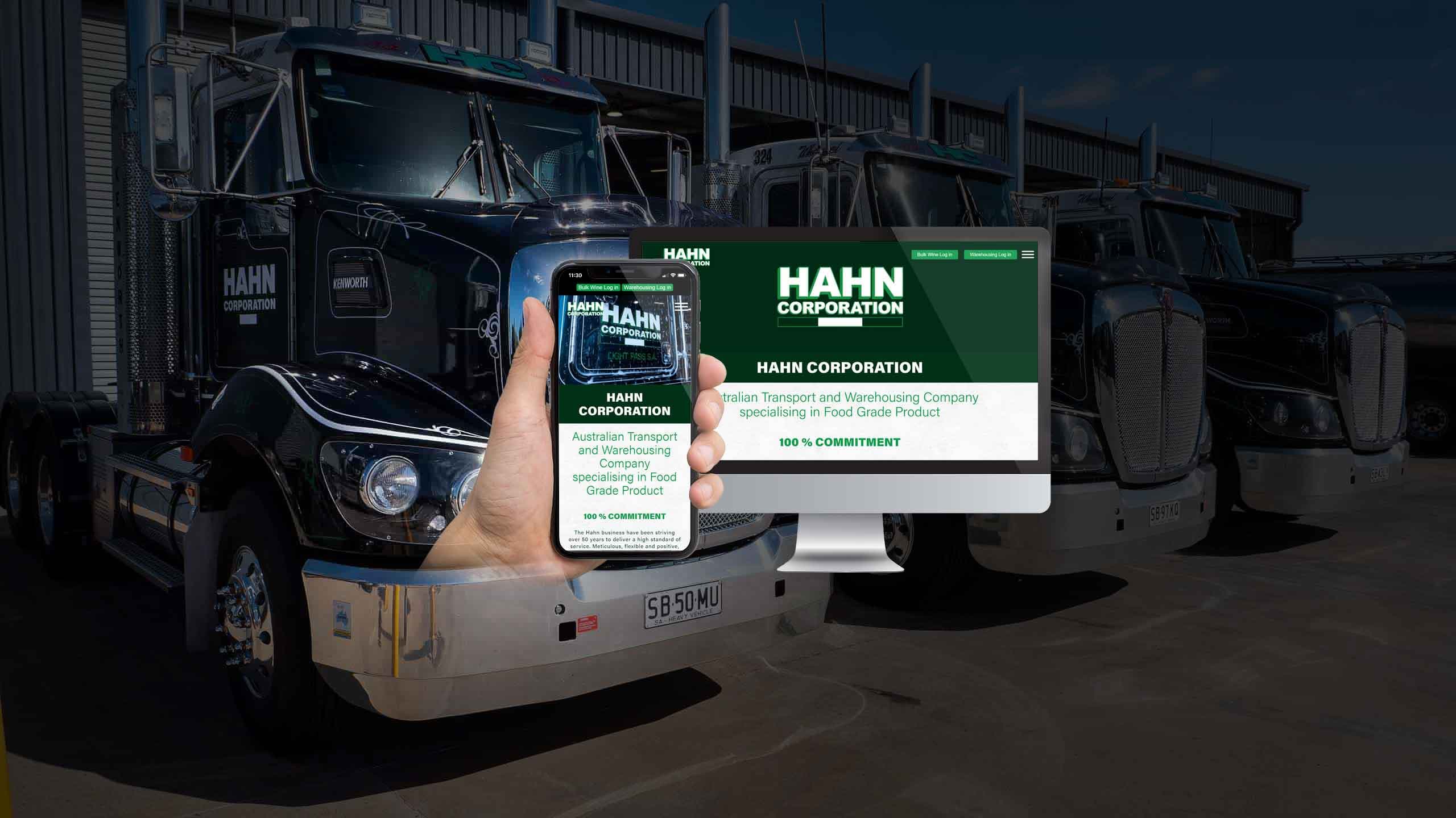 Hahn Corporation website on desktop and smartphone in front of the company's transport trucks