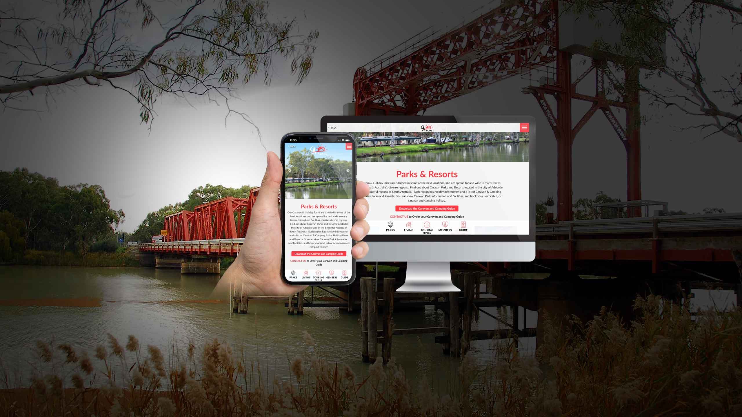 SA Parks website Parks & Resorts page on a desktop monitor and smartphone by a red river bridge