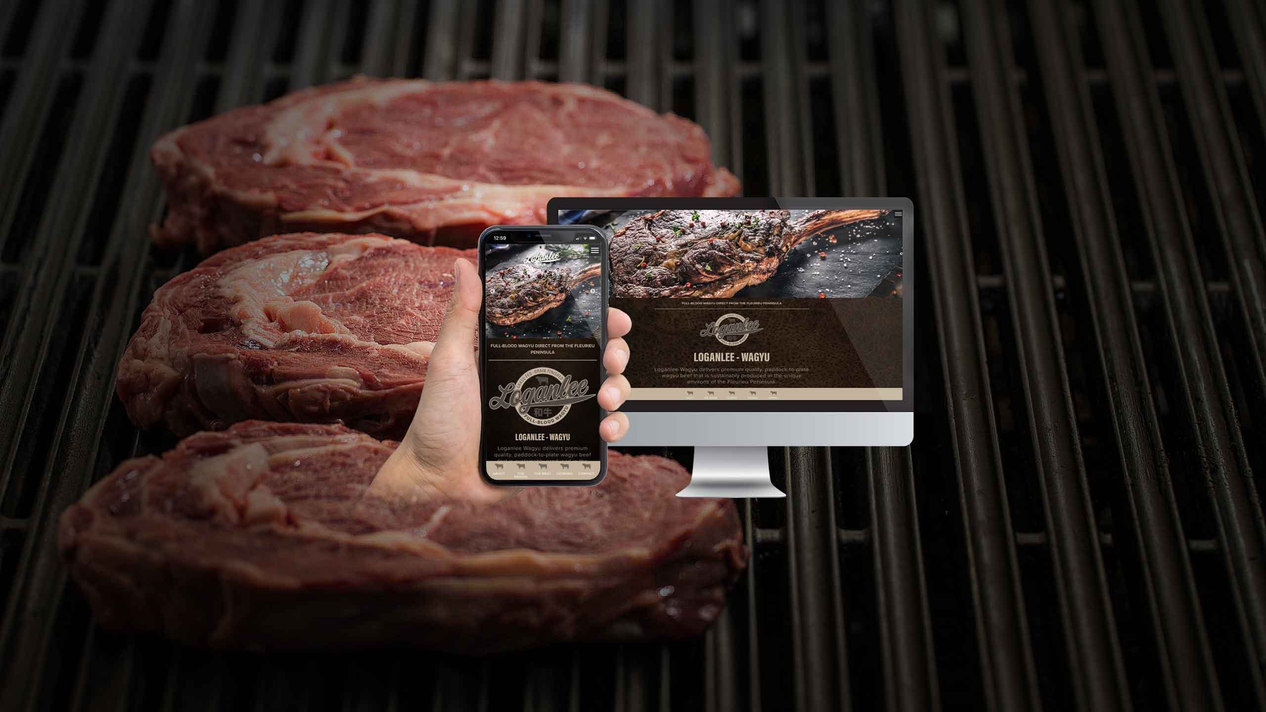 Loganlee Wagyu website homepage on a desktop monitor and smartphone over grilling wagyu steaks