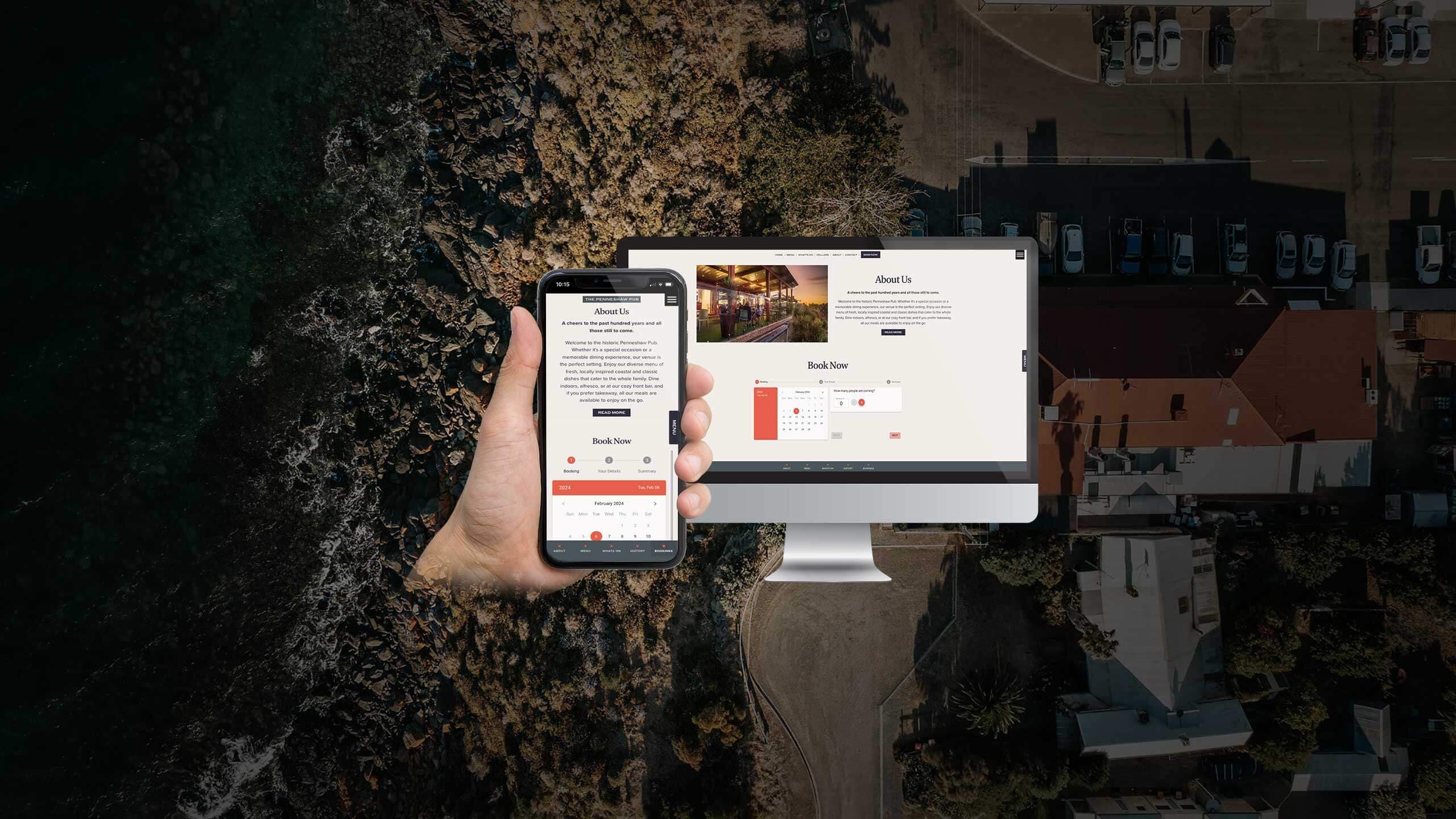 The Penneshaw Pub About Us and booking page displayed on a desktop monitor and smartphone over a coastal view